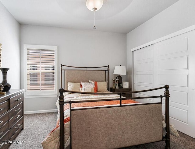 bedroom with a closet, ceiling fan, and carpet flooring