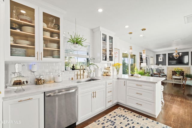 kitchen featuring sink, dishwasher, dark hardwood / wood-style flooring, pendant lighting, and white cabinets