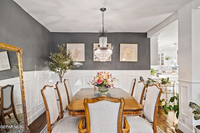 dining space with a notable chandelier and hardwood / wood-style floors