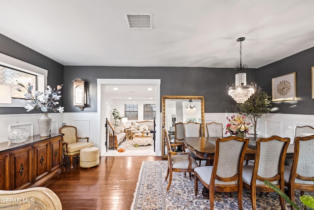 dining area featuring a notable chandelier and dark hardwood / wood-style floors