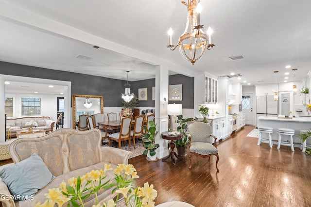 living room with a chandelier and dark hardwood / wood-style floors