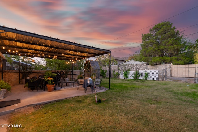 yard at dusk featuring a patio area