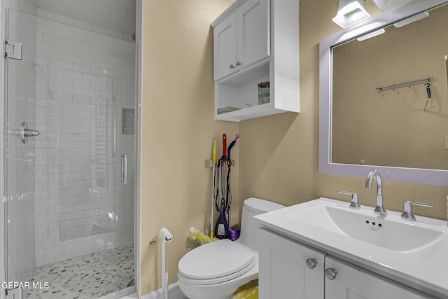 bathroom featuring vanity, toilet, and an enclosed shower