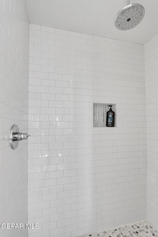 bathroom with tiled shower