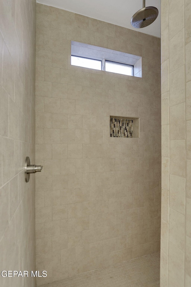 bathroom with a tile shower