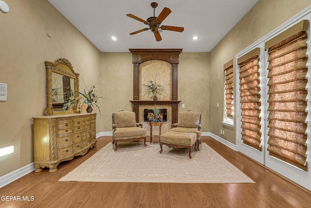 living area featuring ceiling fan and hardwood / wood-style flooring