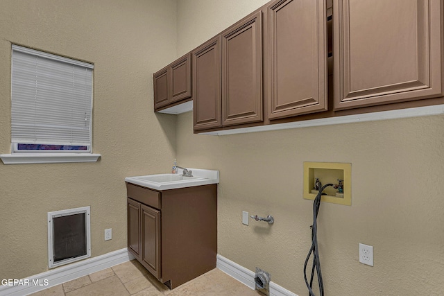 laundry area featuring sink, washer hookup, and cabinets