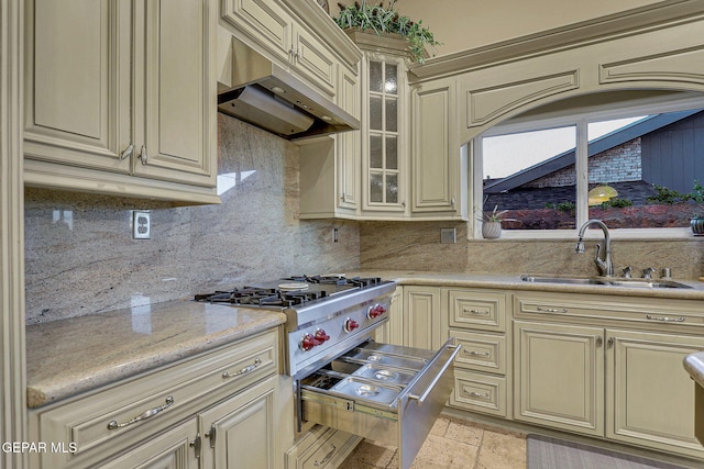 kitchen featuring sink, tasteful backsplash, cream cabinets, and extractor fan