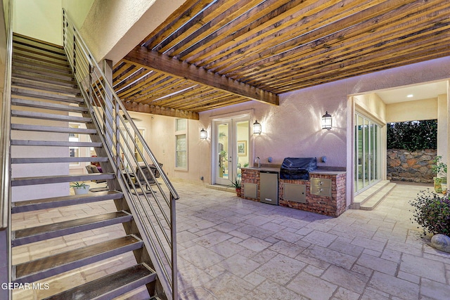 stairway featuring french doors and sink