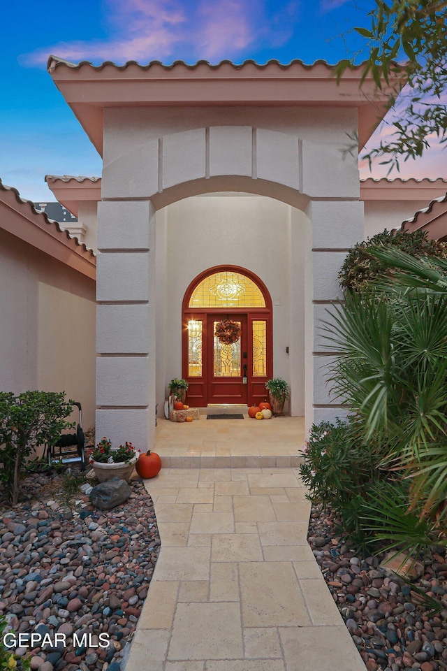 exterior entry at dusk with french doors