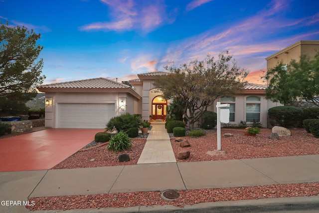 mediterranean / spanish-style home featuring a garage