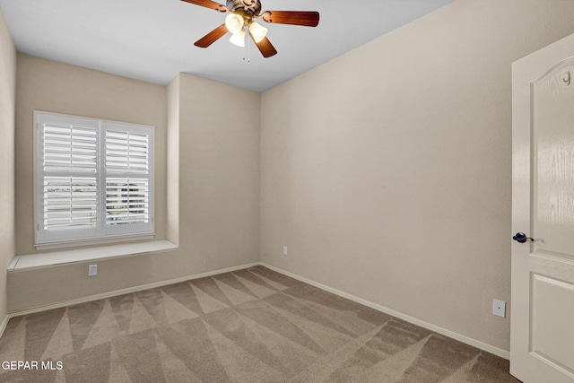 empty room with light colored carpet and ceiling fan