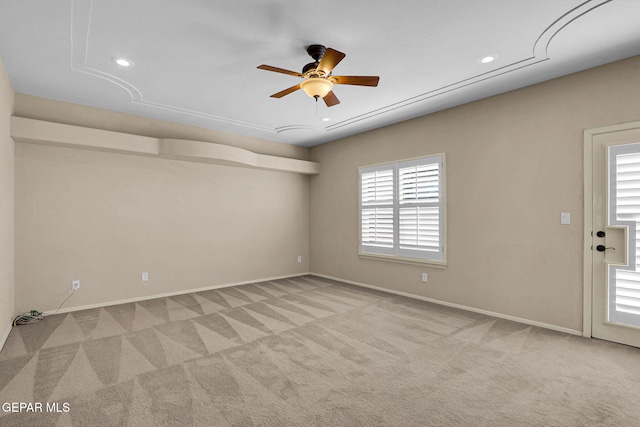 empty room featuring light carpet and ceiling fan