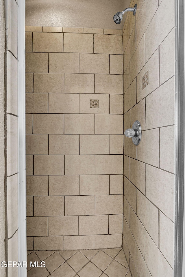 bathroom with a tile shower