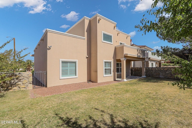 back of property featuring a yard and a balcony