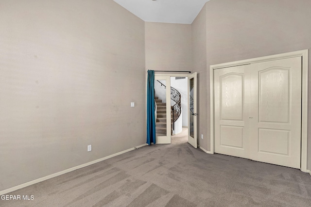 unfurnished bedroom featuring carpet floors and a closet