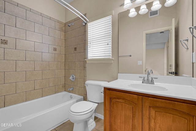 full bathroom with vanity, tiled shower / bath combo, toilet, and tile patterned floors