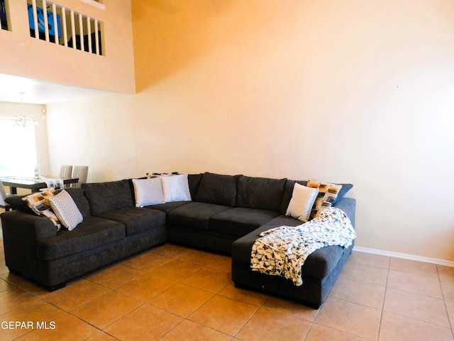 living room featuring tile patterned flooring and a notable chandelier