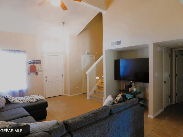 living room with high vaulted ceiling, ceiling fan, and light tile patterned flooring