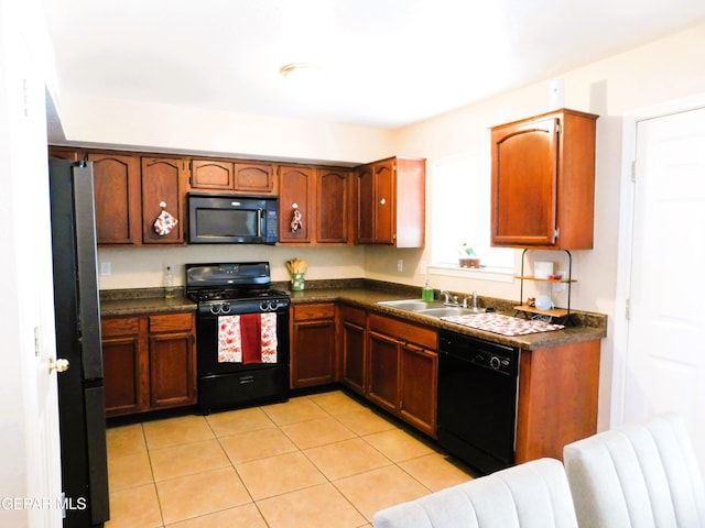 kitchen with light tile patterned floors, sink, and black appliances