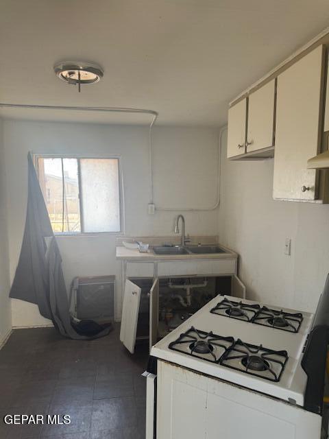 5600 Joe Perez Ct, El Paso, TX 79905 - kitchen featuring a sink, white gas stove, white cabinetry, and light countertops