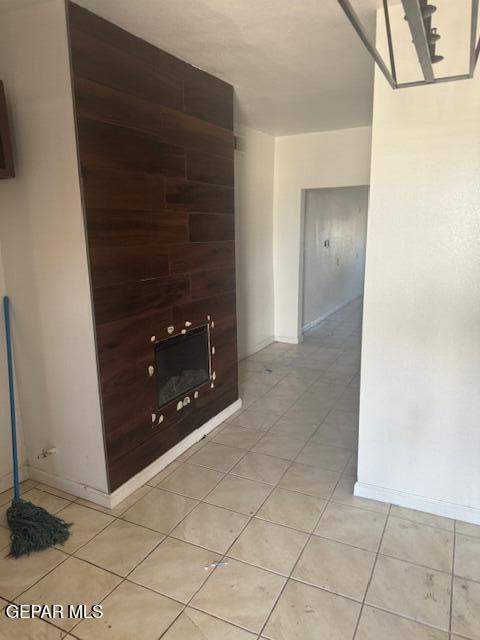 5600 Joe Perez Ct, El Paso, TX 79905 - unfurnished living room with baseboards and light tile patterned flooring