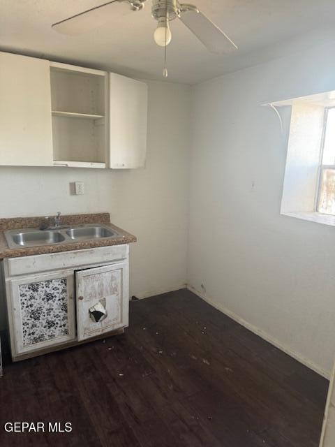 5600 Joe Perez Ct, El Paso, TX 79905 - kitchen with a sink, dark wood finished floors, a ceiling fan, and white cabinetry