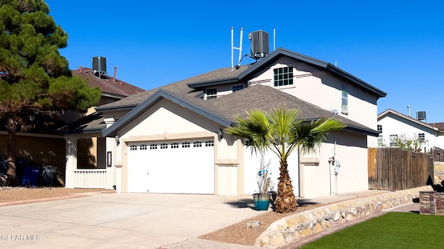 view of front facade featuring cooling unit and a garage