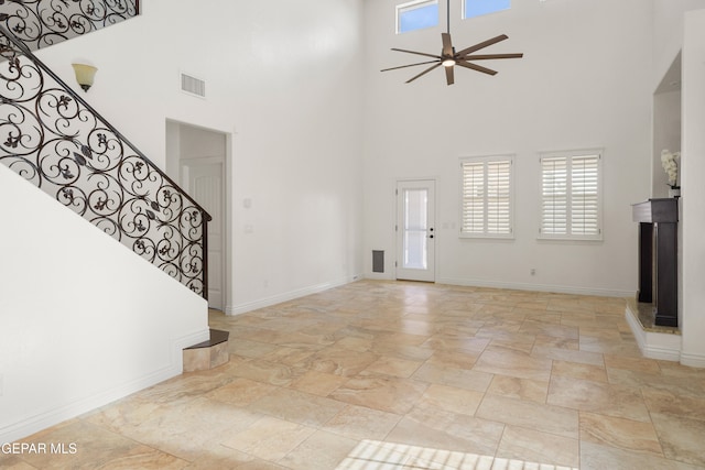 entrance foyer featuring a high ceiling and ceiling fan