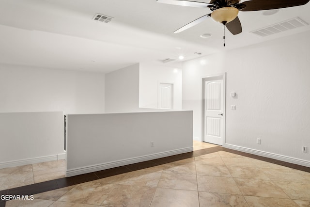 tiled empty room with ceiling fan