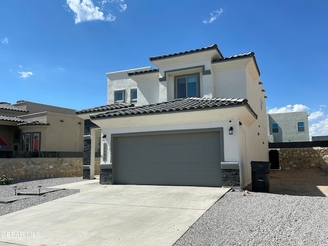 mediterranean / spanish-style home with a garage