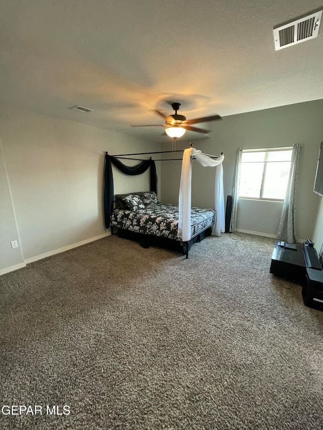 unfurnished bedroom featuring carpet floors, a textured ceiling, and ceiling fan