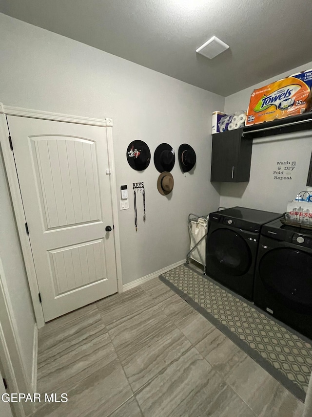 laundry area with cabinets and washing machine and clothes dryer