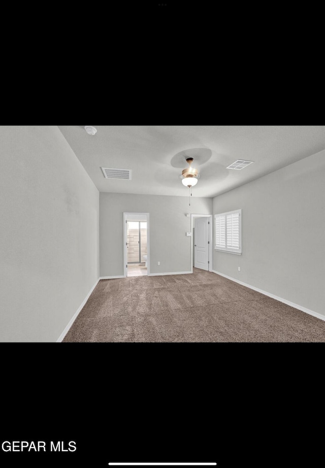 carpeted empty room with ceiling fan