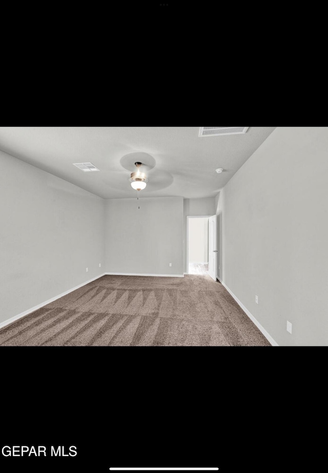 carpeted empty room featuring ceiling fan