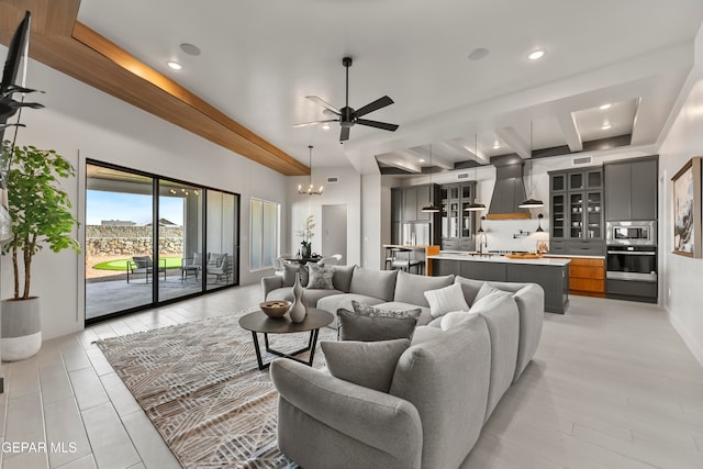 living room featuring sink, vaulted ceiling with beams, light wood-type flooring, and ceiling fan