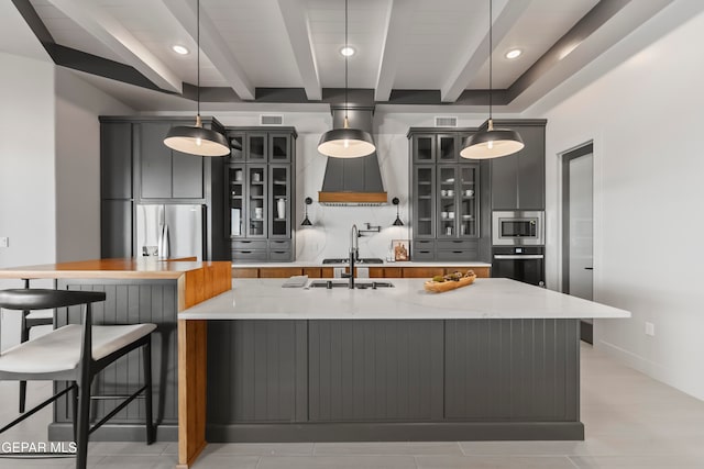 kitchen with beamed ceiling, stainless steel appliances, and hanging light fixtures