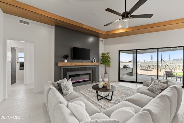 living room with light hardwood / wood-style floors and ceiling fan