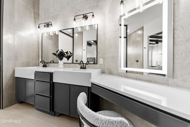 bathroom with tile walls, vanity, ceiling fan, and tile patterned floors