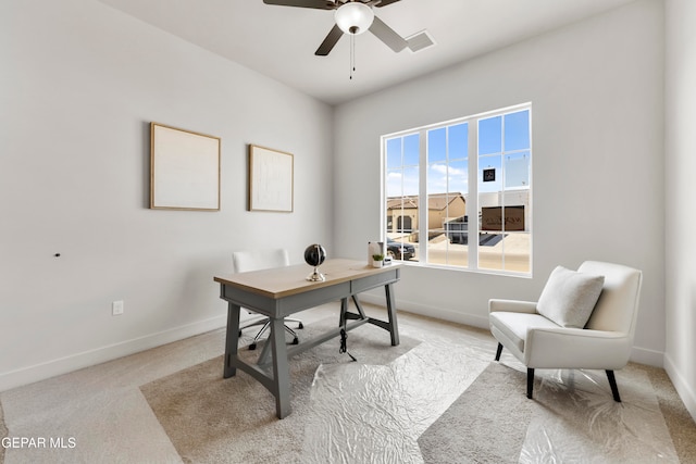 office featuring light carpet and ceiling fan