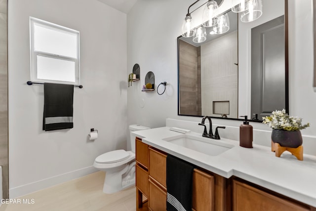 bathroom featuring vanity, hardwood / wood-style floors, and toilet