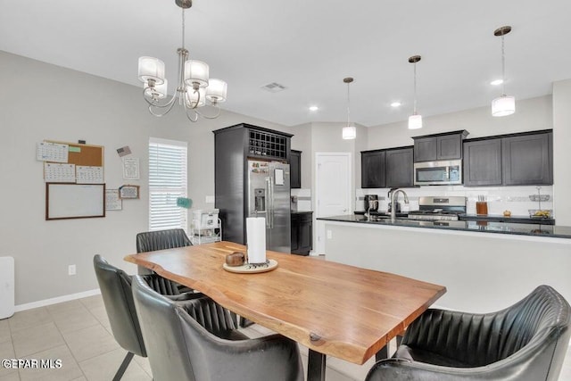 tiled dining space with sink and a chandelier