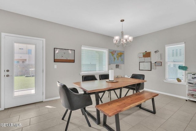 tiled dining space featuring an inviting chandelier