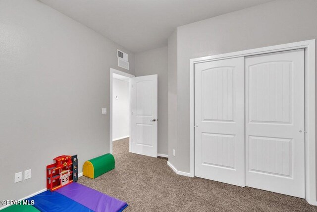 game room featuring dark colored carpet