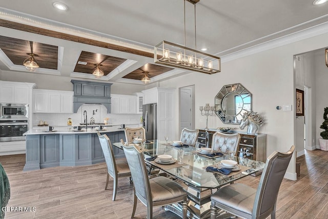 dining space featuring beamed ceiling, ornamental molding, coffered ceiling, and light hardwood / wood-style floors