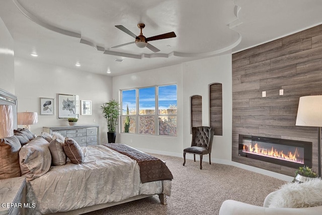 bedroom with ceiling fan, carpet flooring, and a fireplace