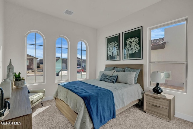 bedroom featuring light colored carpet