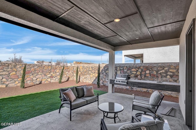 view of patio with area for grilling and an outdoor kitchen