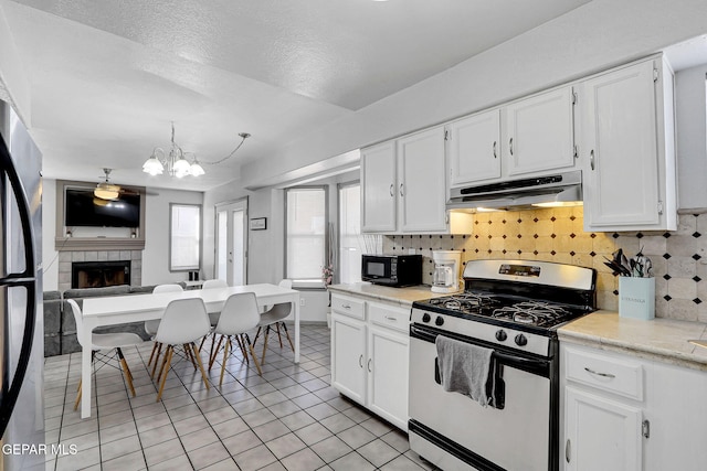 kitchen featuring white cabinetry and range with gas cooktop