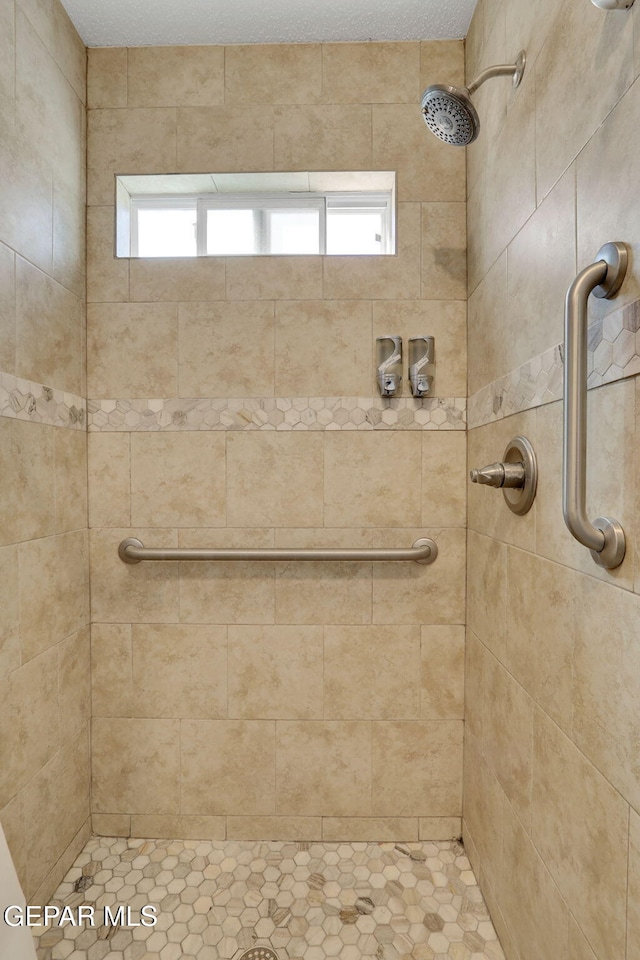 bathroom with a tile shower